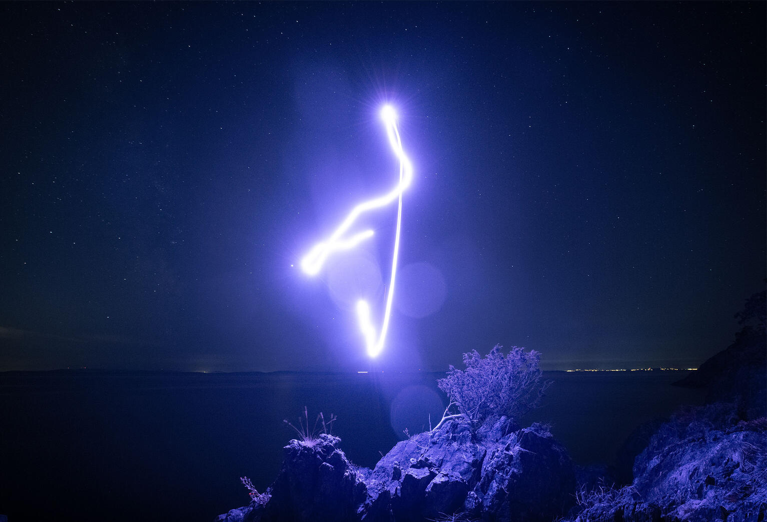 Attune. A single gesture drawn with light. Part signal, part surrender. The land waits. The sky listens. And for a brief moment, everything aligns.